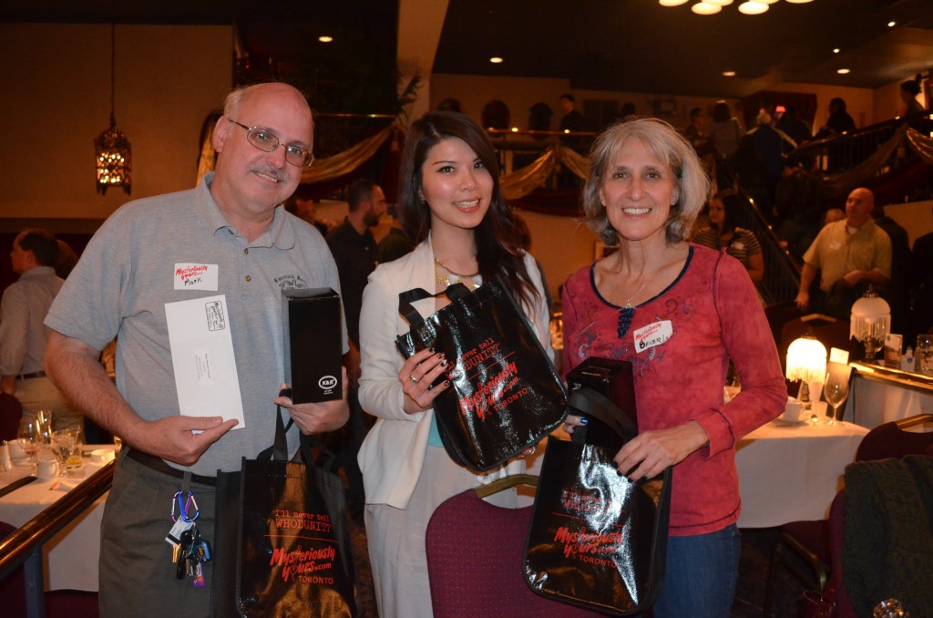 Guests who have guessed whodunit receive their prizes (L-R: Mark Cavanagh, Vanessa Hung, Beverly Cavanagh)