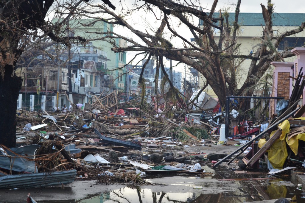 Debris lines the streets of Tacloban, Leyte island. This region was the worst affected by the typhoon, causing widespread damage and loss of life. Caritas is responding by distributing food, shelter, hygiene kits and cooking utensils. (Photo: Eoghan Rice - Trócaire / Caritas; Wikipedia)