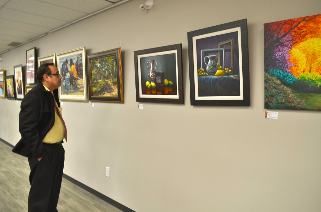 One of the guests viewing paintings by Filipino Artists/ Photos by Thessa Sandoval