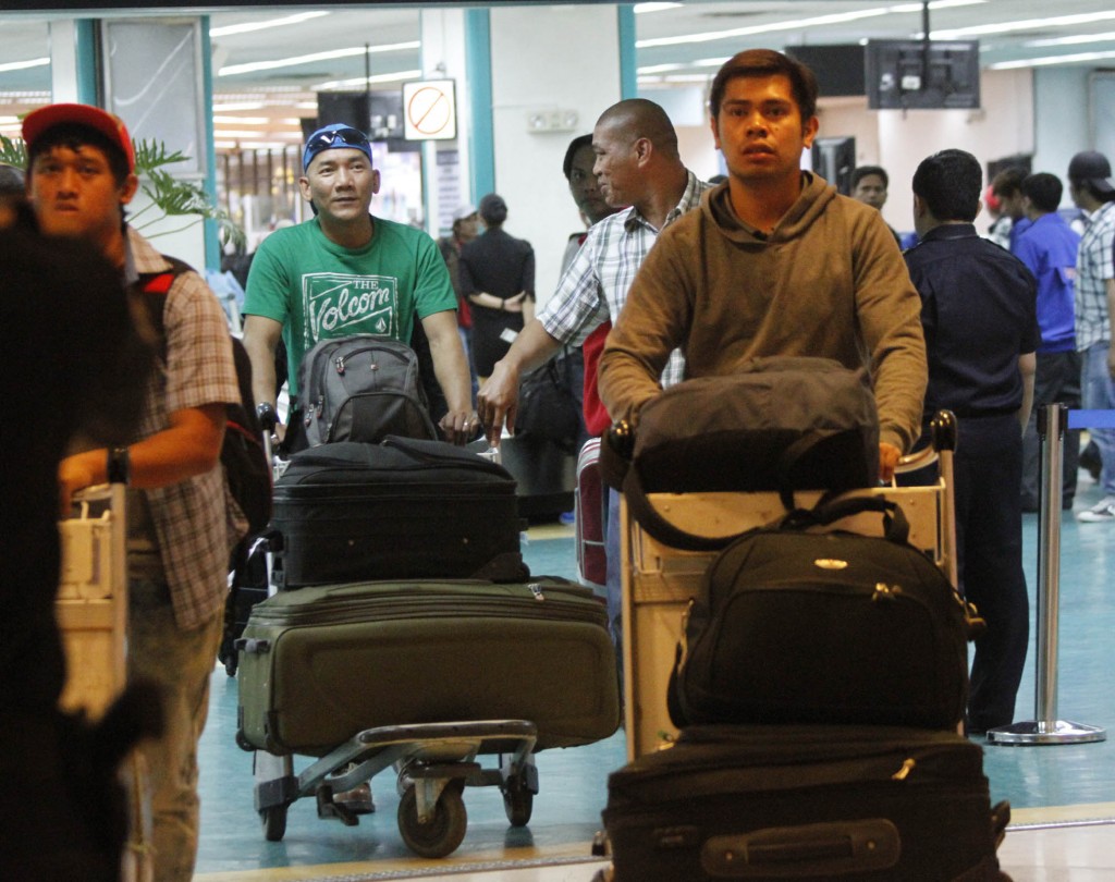 The 65 overseas Filipino workers (OFW) repatriated from Libya thru the effort of the Philippine government arrive at the Ninoy Aquino International Airport (NAIA) on Monday (June 23, 2014) in Pasay City. (PNA photos by Avito C. Dalan)