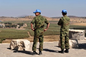 UNDOF soldiers examine the Israeli-Syrian border in Golan Heights, Israel. (Chameleons Eye / ShutterStock)