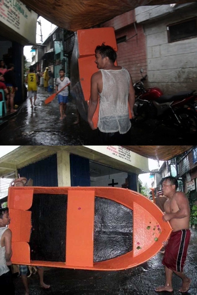 Unmindful of the cold weather amid heavy rainfall, some male residents of Barangay Kristong Hari in Quezon City volunteer to bring out four rubber boats from the barangay hall to be used in evacuating families whose houses were submerged partly in floodwater in low-lying areas of Dona Juana St. near the Roxas District Creek in Quezon City on Friday (Sept. 19, 2014). Some 1,000 families were transferred to safe evacuation sites. (PNA photos by Leilani S. Junio)