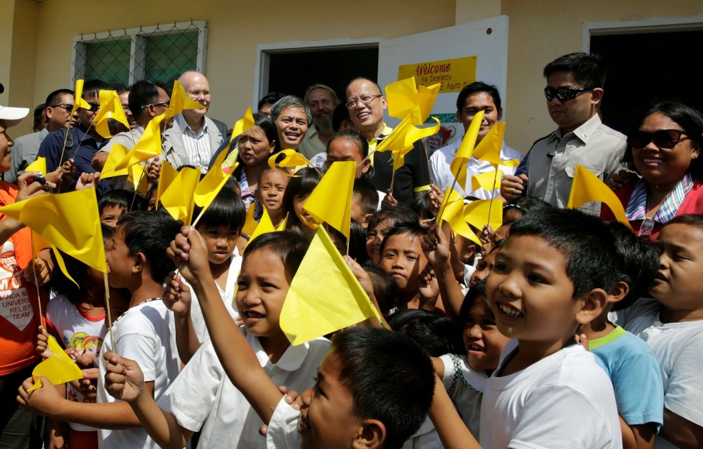 President Benigno S. Aquino III poses with pupils of the newly repaired classrooms of Guiuan East Central School in Barangay 8, Poblacion, Guiuan during the visit to the province of Eastern Samar on Friday (November 07). It was in Guiuan where super Typhoon Yolanda, the strongest typhoon ever recorded, made its first landfall on November 08, 2013. (Photo by Gil Nartea / Malacañang Photo bureau)