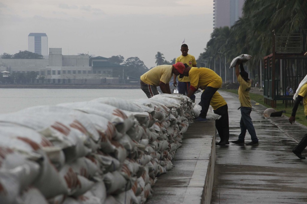 Metropolitan Manila Development Authority (MMDA) personnel put sandbags along a portion of the Roxas Blvd. Baywalk in Manila as part of the precaution against possible storm surges that maybe caused by Tropical Storm "Ruby" which is expected to pass south of Metro Manila on Monday evening (Dec. 8, 2014). (PNA photo by Avito C. Dalan)