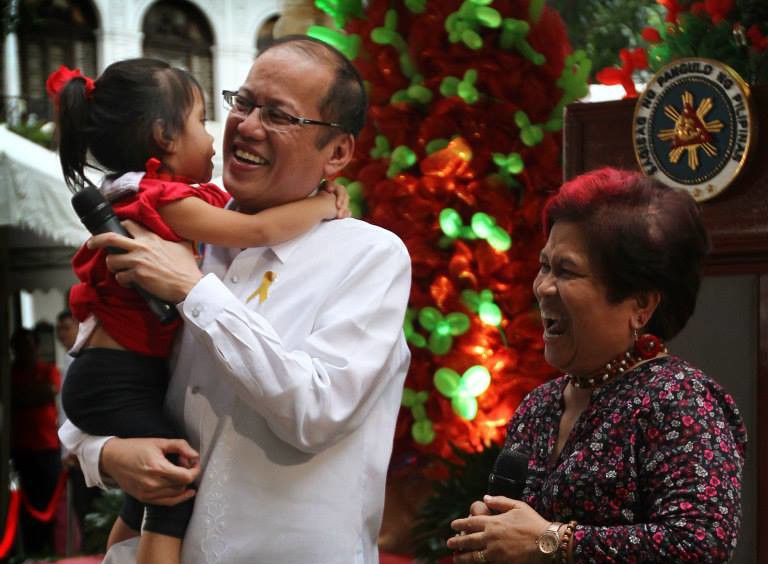 President Benigno S. Aquino III carries a child during the Pasko ng Batang Pinoy 2014 at the Kalayaan Grounds of the Malacañan Palace on Friday (December 19, 2014). The Pasko ng Batang Pinoy Project is part of The DSWD's program to provide the street children a venue for self-enhancement through various activities to enjoy the spirit of Christmas while impede them from going out the streets especially this yuletide season. Also in photo is Social Welfare and Development Secretary Corazon Juliano-Soliman. (Photo by Exequiel Supera / Malacañang Photo Bureau / PCOO)