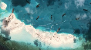 This handout photo taken on March 17, 2015 by satellite imagery provider DigitalGlobe and released to AFP by the Asia Maritime Transparency Initiative department at the Center for Strategic and International Studies (CSSI) think tank shows a satellite image of vessels purportedly dredging sand at Mischief Reef in the Spratly Islands in the disputed South China Sea.  The series of satellite images posted on the website of the Center for Strategic and International Studies last week show a flotilla of Chinese vessels dredging sand onto Mischief Reef and the resulting land spreading in size. Beijing on April 9 reaffirmed its right to build on the disputed islands after the satellite imagery emerged of construction operations turning tropical reefs into concrete artificial islands. The Philippines, Vietnam, Malaysia, Brunei and Taiwan all have overlapping claims in the area. (AFP Photo / CSIS Asia Maritime Transparency Initiative / DigitalGlobe)