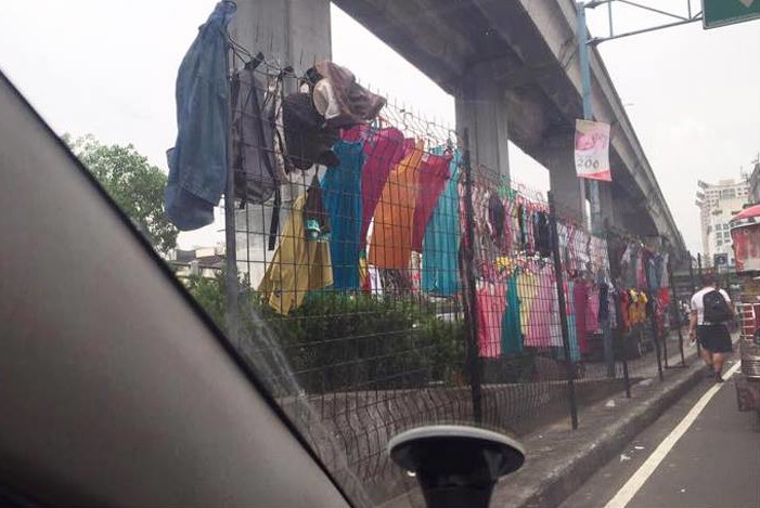 MMDA steel fences along Aurora Boulevard in EDSA turned into clotheslines (Photo by Richard Ong via Top Gear Philippines)