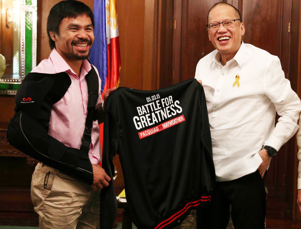 President Benigno S. Aquino III receives a black jacket from Sarangani Lone District Representative Emmanuel Manny Pacquiao during the courtesy call at the Music Room of the Malacañan Palace on Wednesday (May 13, 2015). (Photo by Ryan Lim / Malacañang Photo Bureau)