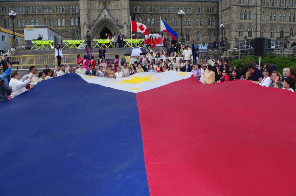 A giant Philippine flag is unfurled at Parliament Hill