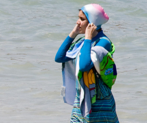 Even though it’s only worn by a tiny minority, the burkini – a wetsuit-like garment that covers the torso, limbs and head – has prompted a national discussion about Islam and women’s bodies. (Photo: Giorgio Montersino/Flickr)