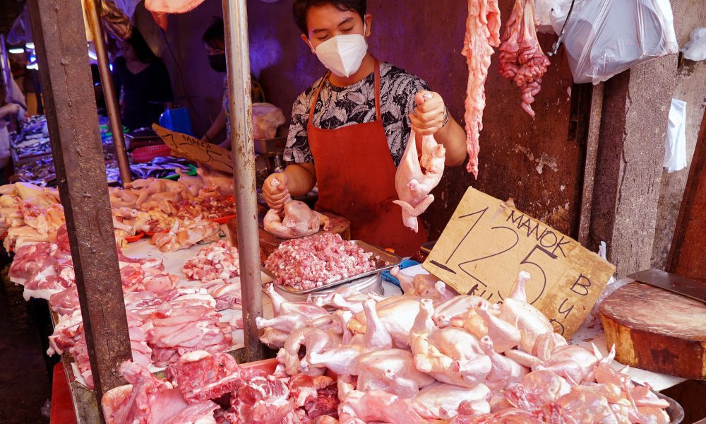 Vendor selling chicken meat in public market