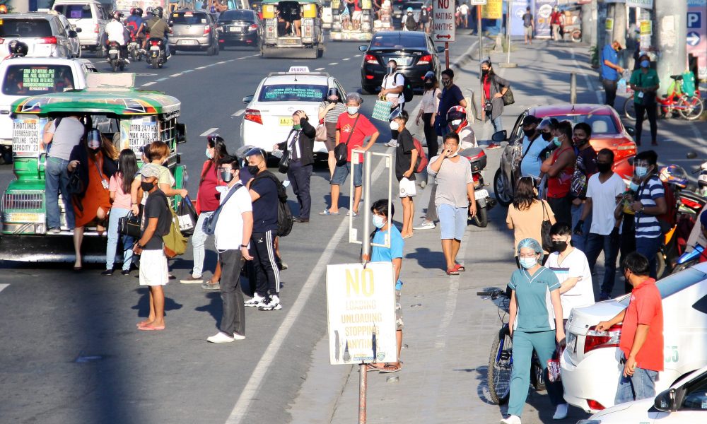 Commuters waiting for rides in Marcos Highway