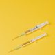 Two injections on a yellow background