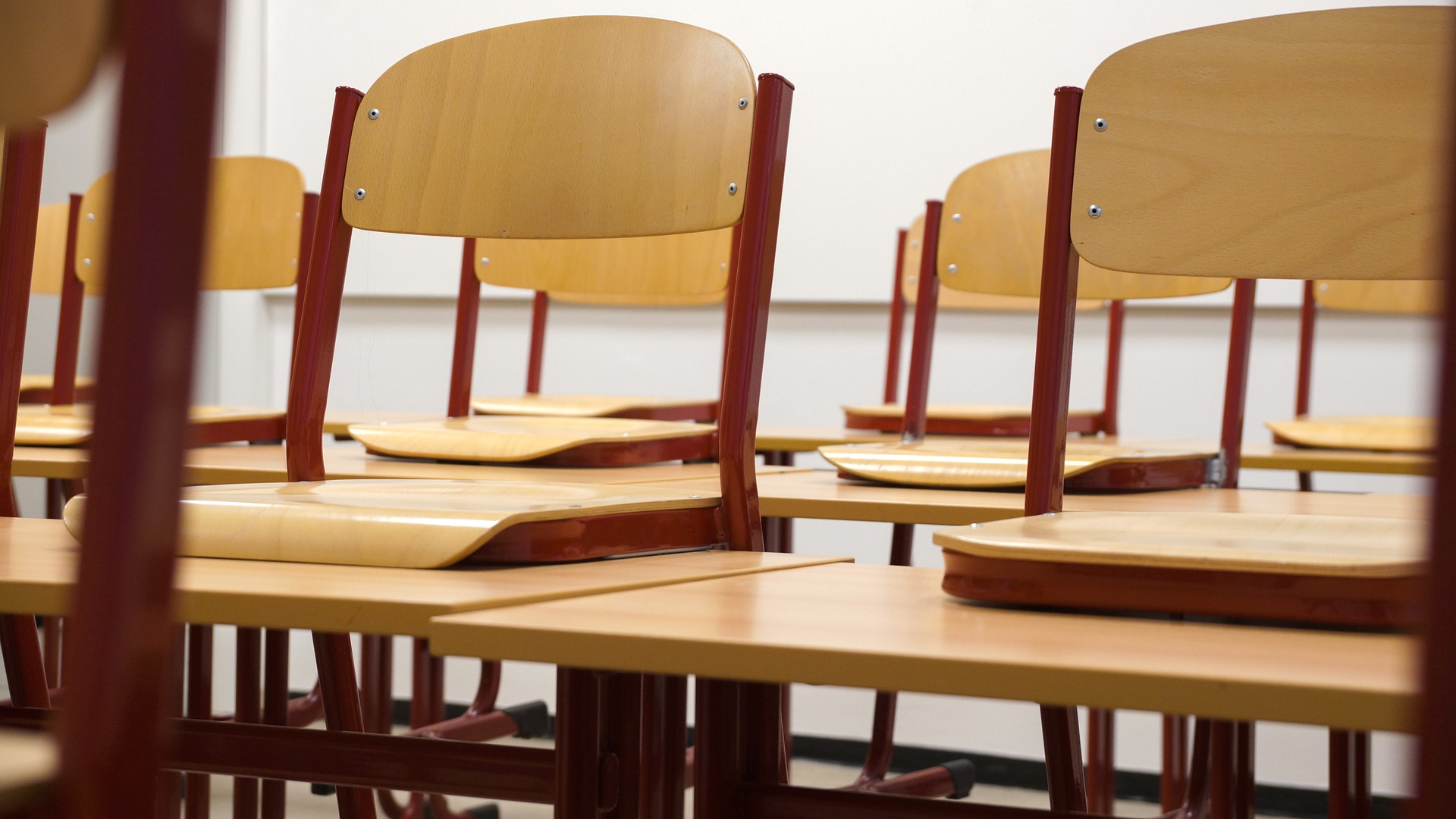 lines of student arm chairs in a classroom