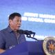 Duterte giving a speech in a podium