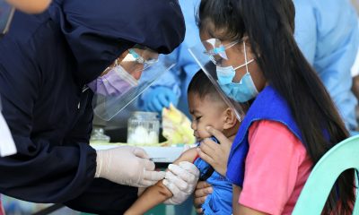 A child gets inoculated with anti-measles vaccine