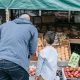 Father and son standing in the fruit market