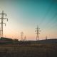 Landscape photography of electric towers under a calm blue sky