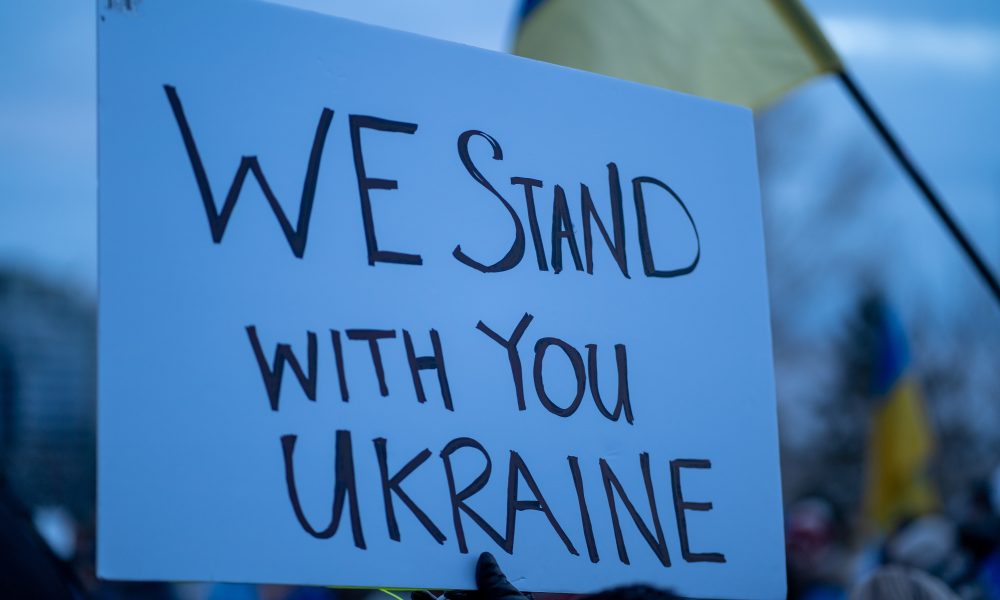 Placard that reads: "We stand with you Ukraine"