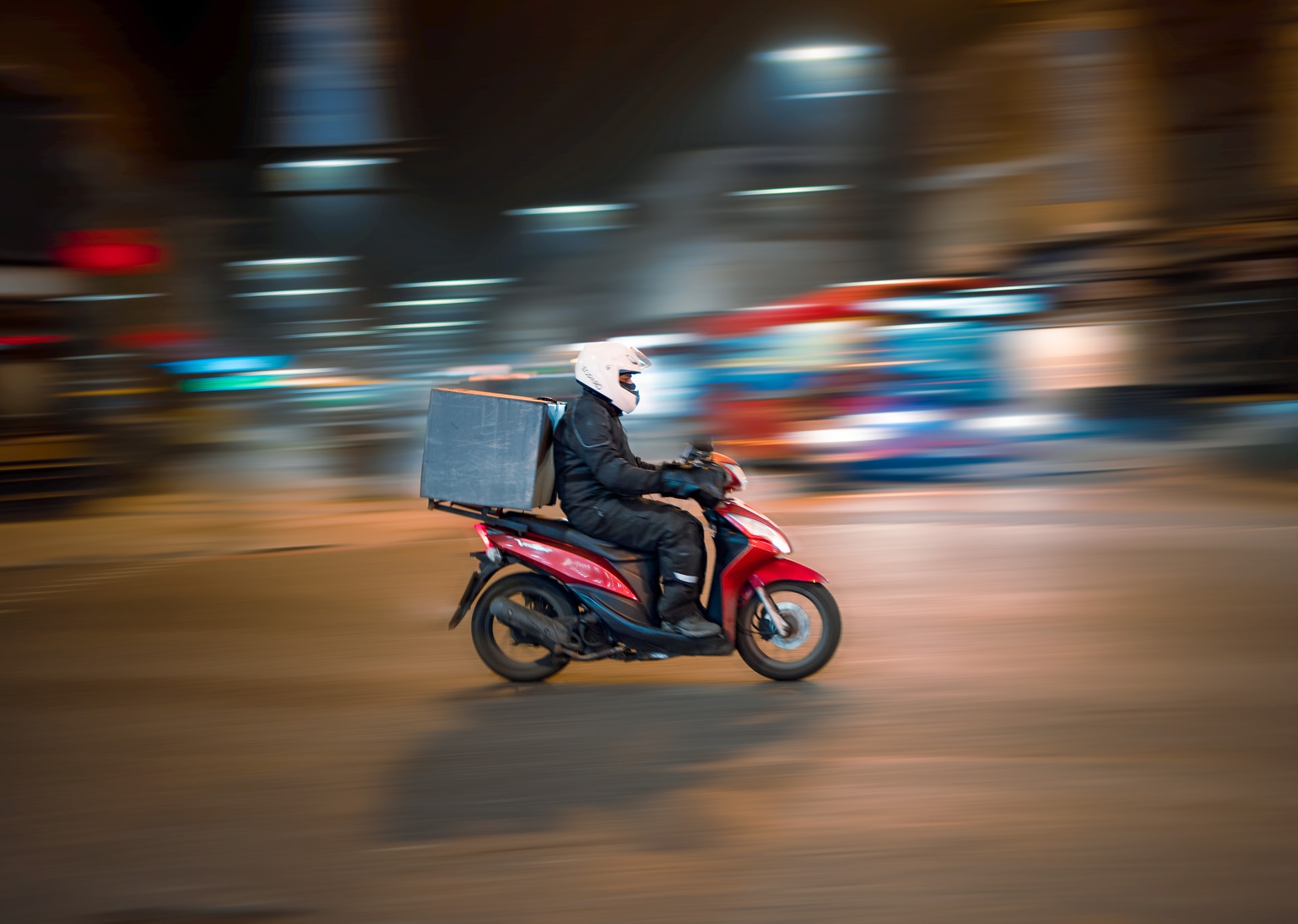 delivery guy riding a motorcycle