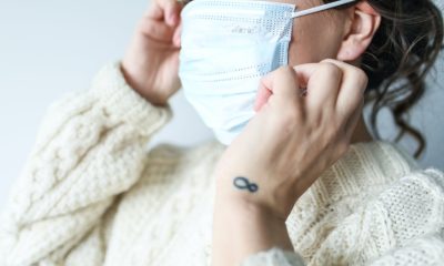 Female holding her mask.