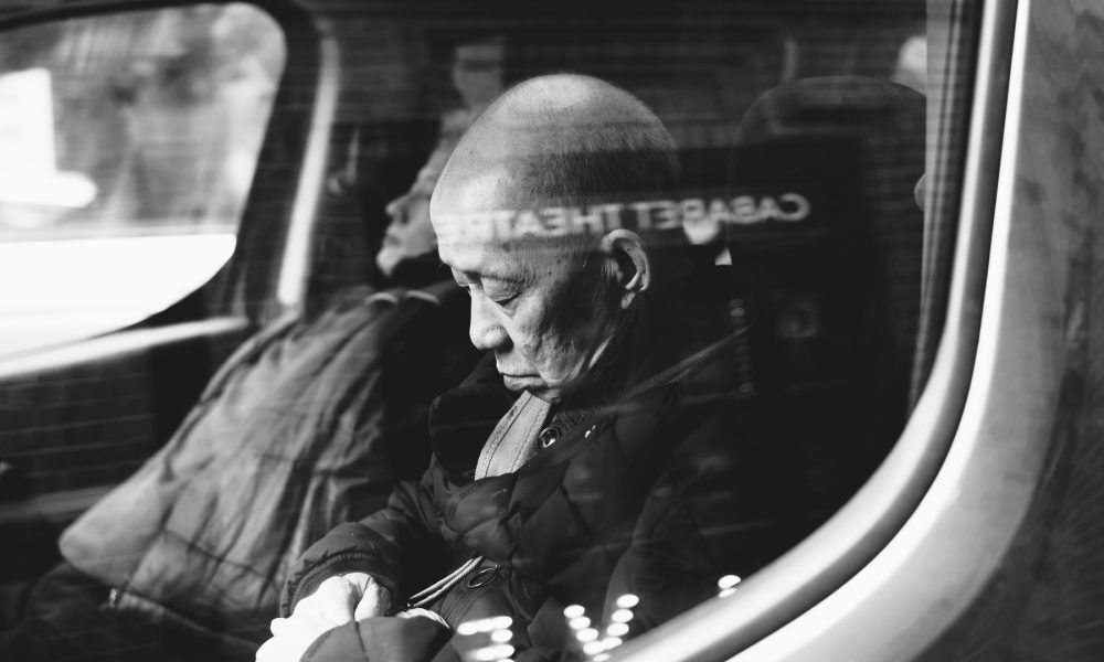 sleeping grandfather inside a vehicle