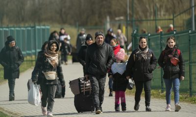 Refugees walk after fleeing the war from neighbouring Ukraine