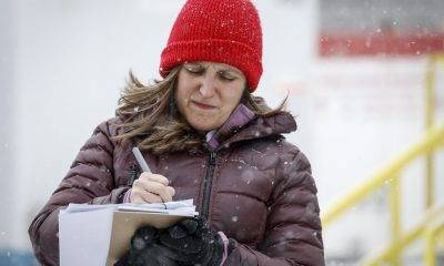 Deputy Prime Minister Chrystia Freeland writing in a paper she holds