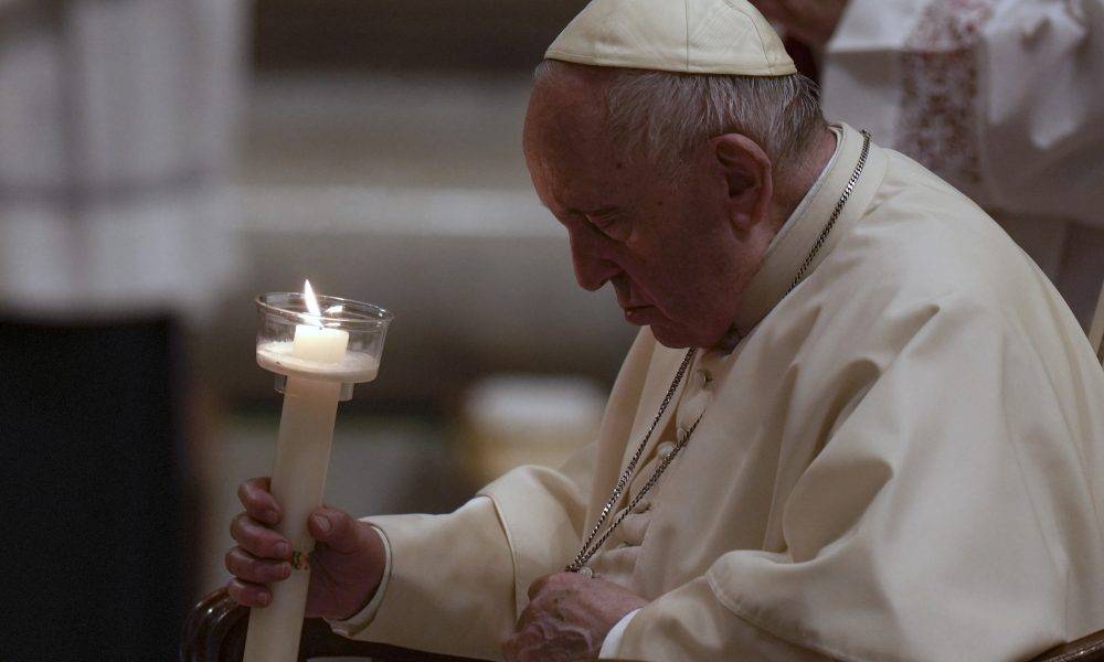 Pope Francis holds a Paschal candle