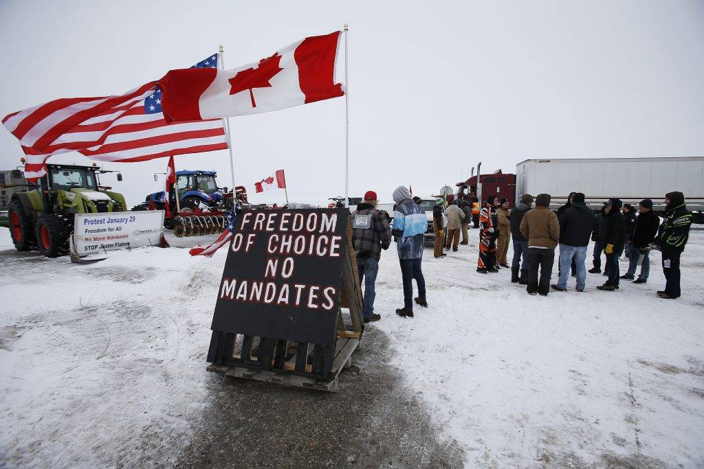 People block highway 75 with heavy trucks and farm equipment and access to the Canada/US border crossing at Emerson, Man., Thursday, Feb. 10, 2022. 