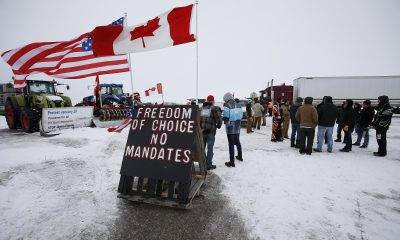 People block highway 75 with heavy trucks and farm equipment and access to the Canada/US border crossing at Emerson, Man., Thursday, Feb. 10, 2022.