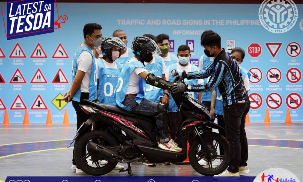 Man guiding a student drive a motorcycle