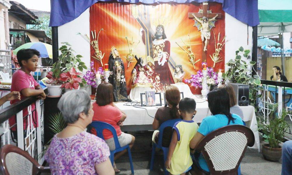 Residents start reading the passion of Christ after a short prayer at the house on Liwag Street corner Delos Reyes Road, Pambuan in Nueva Ecija