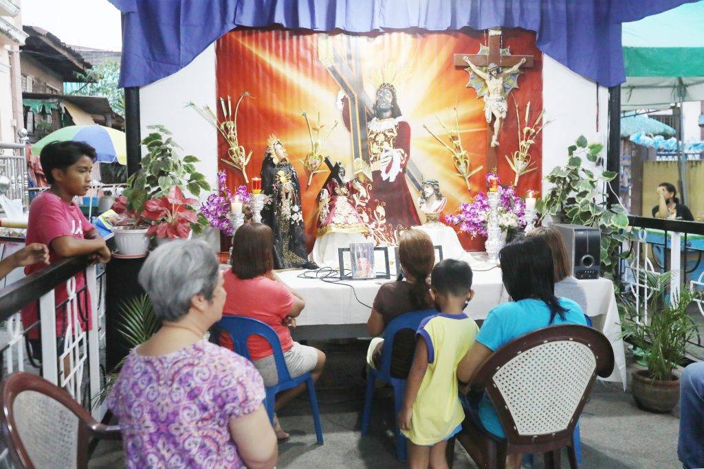 Residents start reading the passion of Christ after a short prayer at the house on Liwag Street corner Delos Reyes Road, Pambuan in Nueva Ecija