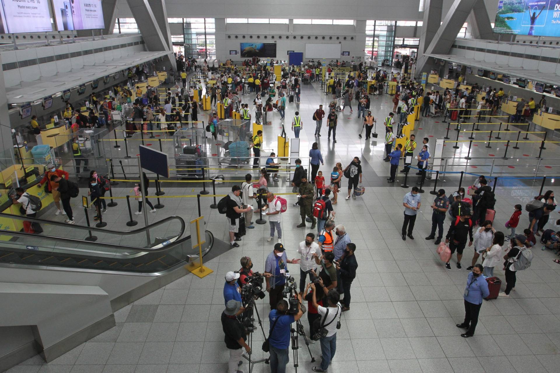 passengers are seen at the check-in counter of Ninoy Aquino International Airport (NAIA) Terminal 3