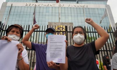 Members of the Akbayan Partylist at the gates of Department of Finance