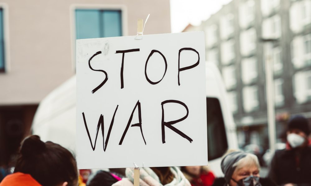Card held with the words Stop War written