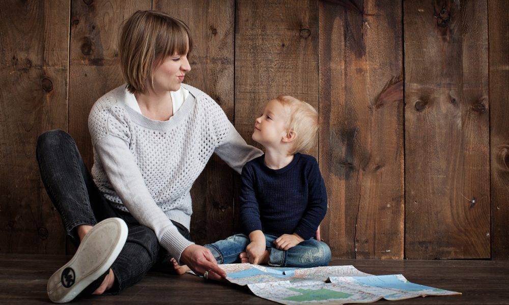 Child with woman holding a map