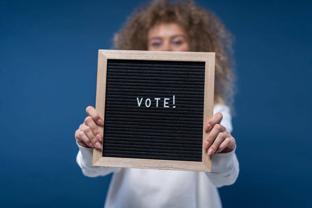 Person holding vote sign