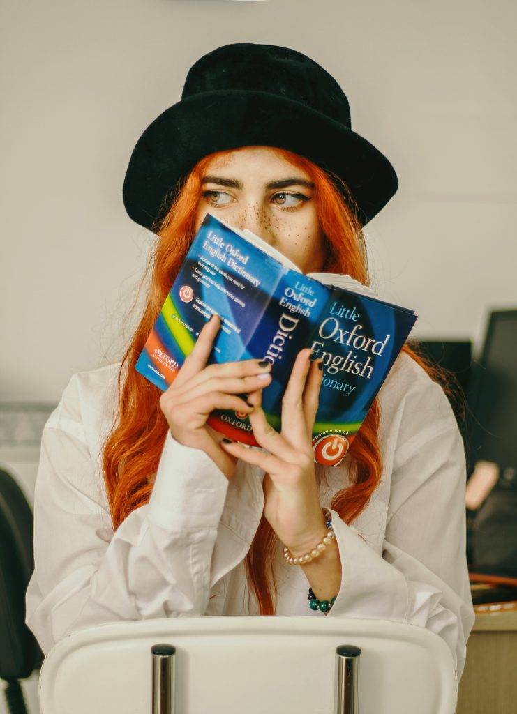 Woman holding Oxford English dictionary