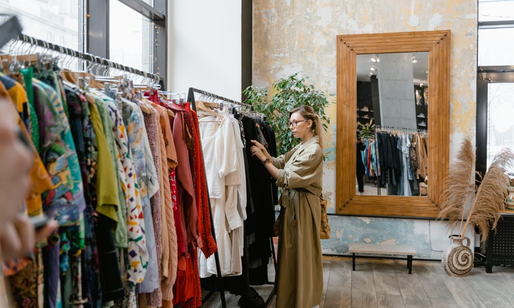 Woman standing near clothes rack