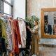 Woman standing near clothes rack