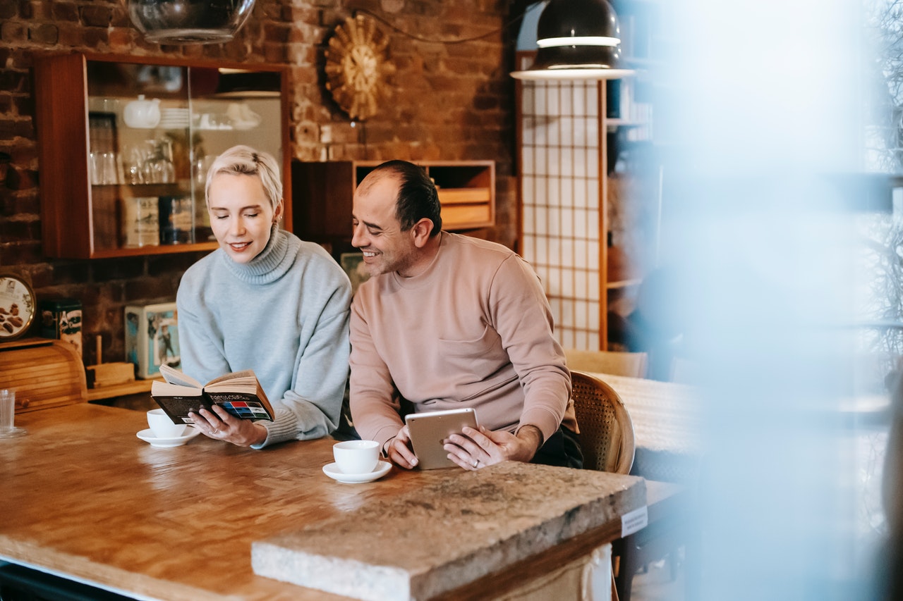 couple reading a book on the table