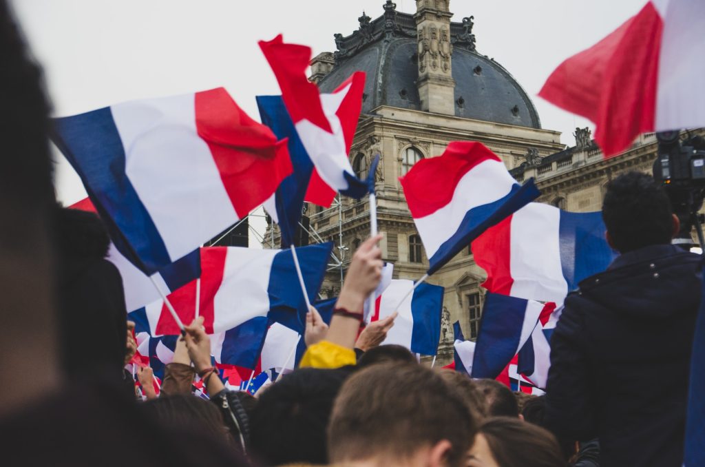 flags of france raised by crowd