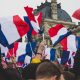 flags of france raised by crowd