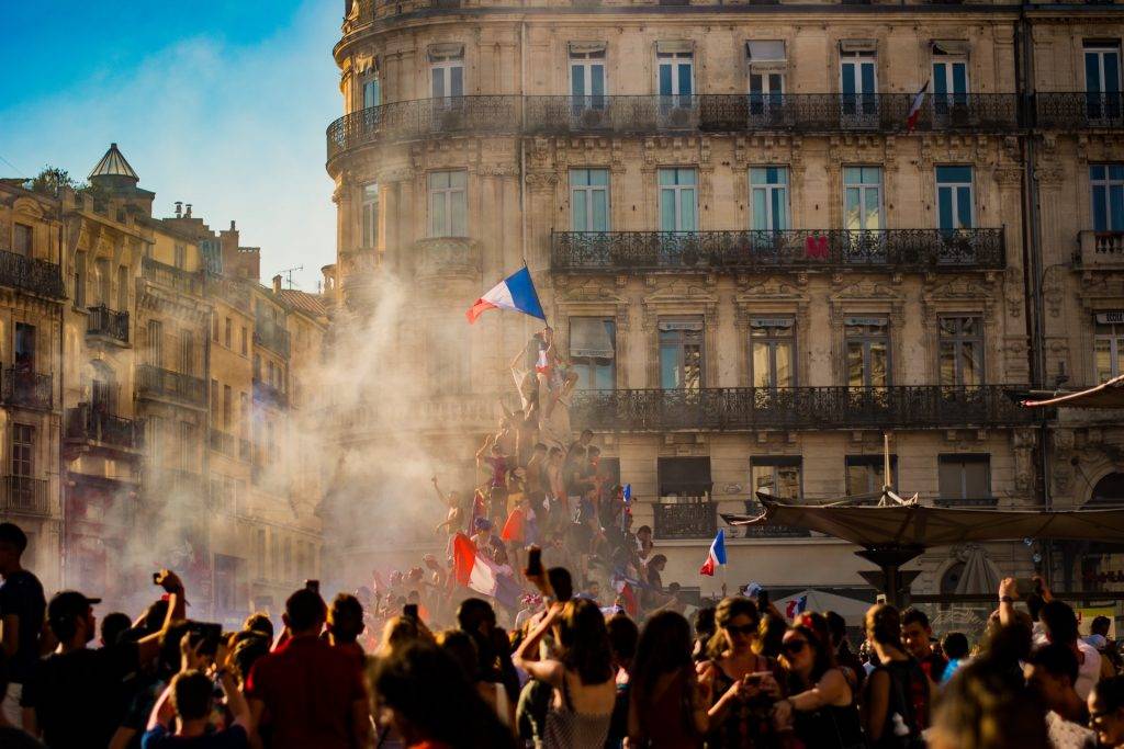 french crowd raising france flag