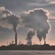 Silhouette of industrial building billowing smoke