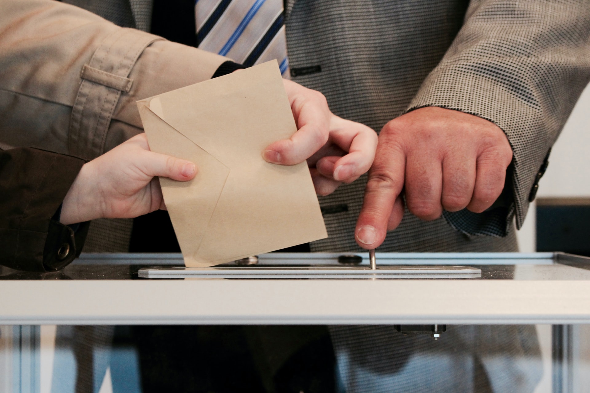 person inserting envelope in a box