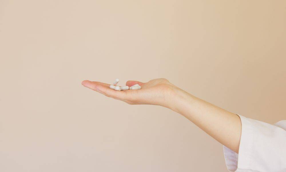 white pills on palm