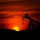 Pump-jack mining crude oil with the sunset